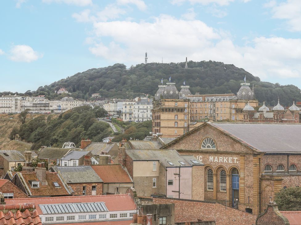 A view of buildings and hills at Launcher's Cottage in Scarborough