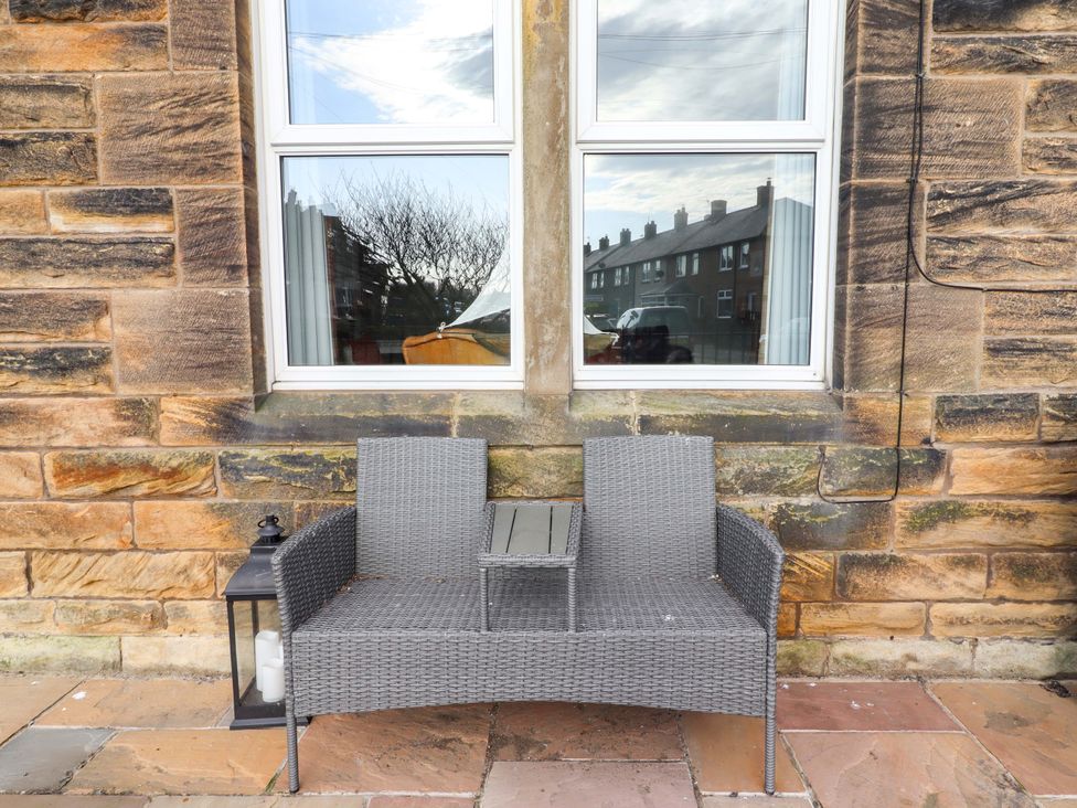 A seating area with a couch and table at Dinguardi Seahouses