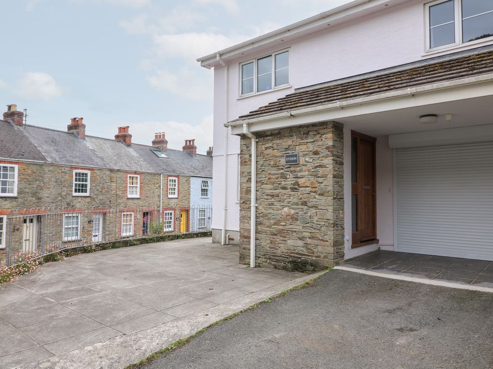 A house exterior with a stone wall and driveway at Eydon in Salcombe