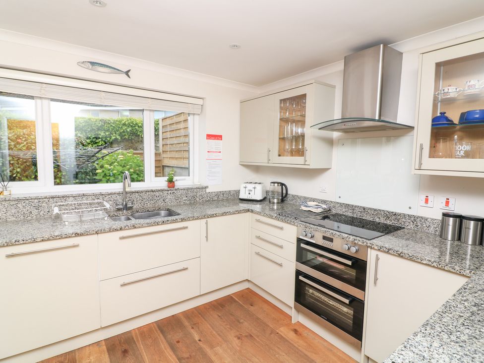 A kitchen with cabinets and appliances at Eydon in Salcombe