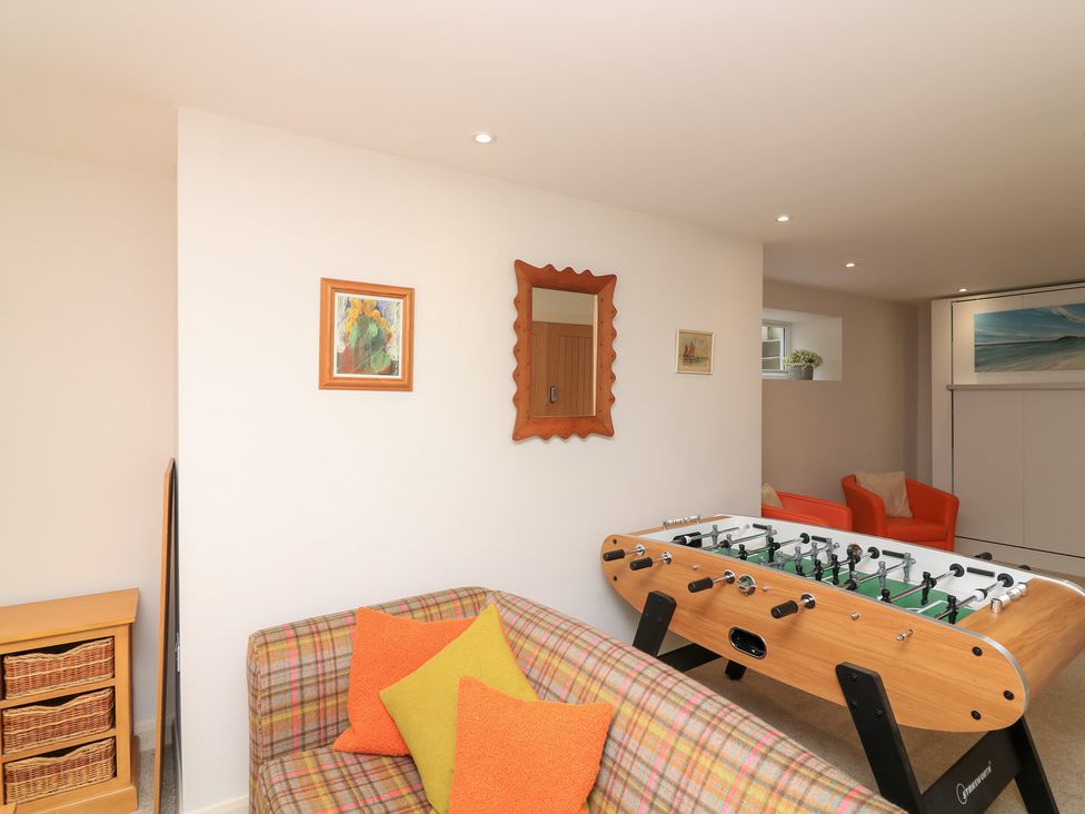A snug with a foosball table and sofa at Eydon in Salcombe