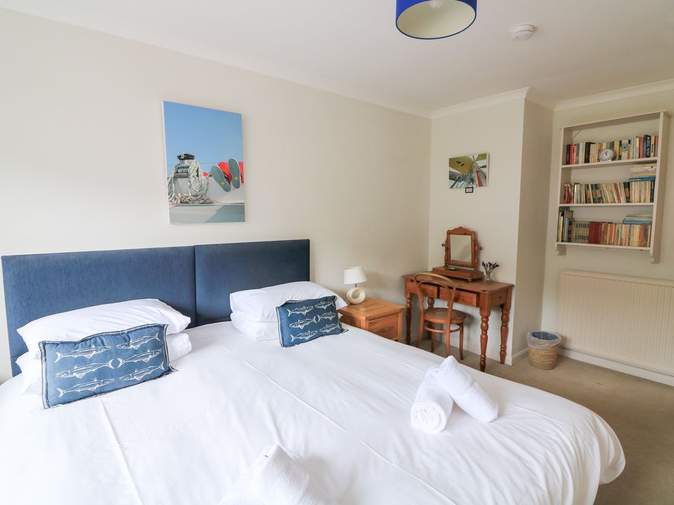 A bedroom with a bed and desk at Eydon in Salcombe