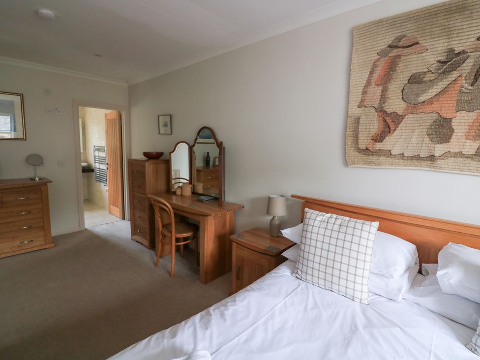 A bedroom with a bed and dresser at Eydon in Salcombe