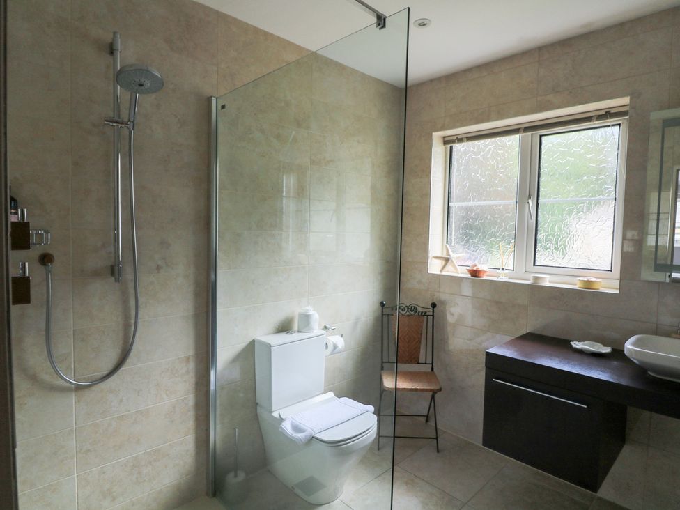 A bathroom featuring a shower, toilet, and sink at Eydon in Salcombe