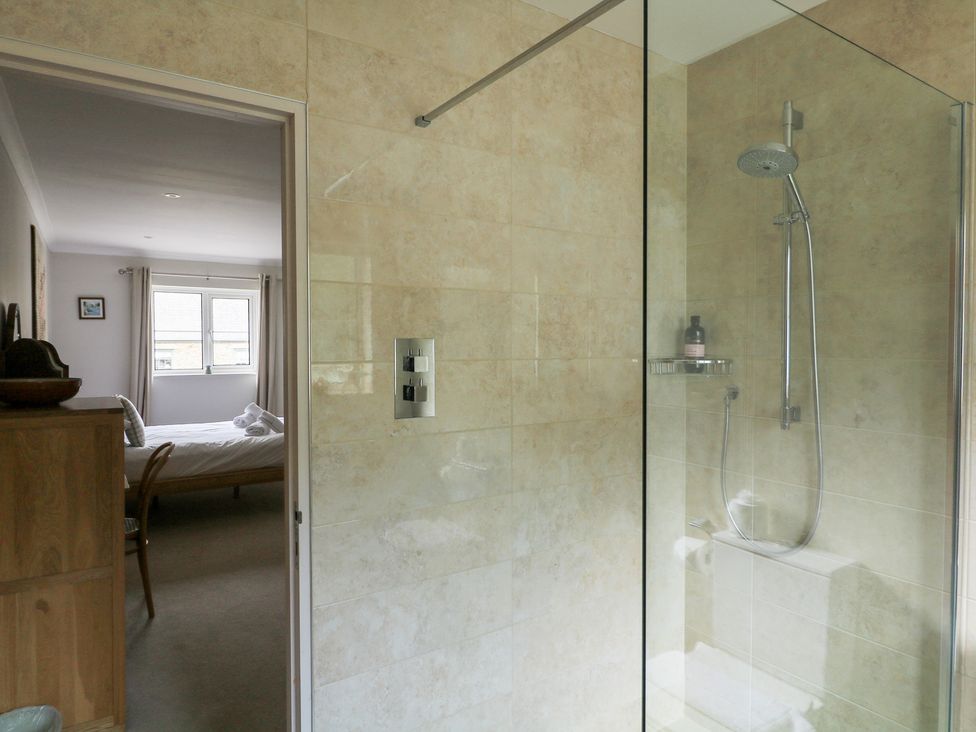 A bathroom featuring a shower and a view of a bedroom at Eydon in Salcombe