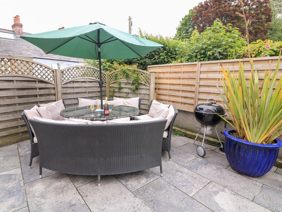 A patio area with a table and chairs at Eydon in Salcombe