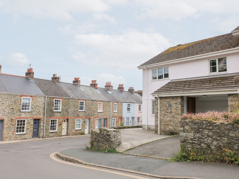 A street with houses and a stone wall at Eydon in Salcombe