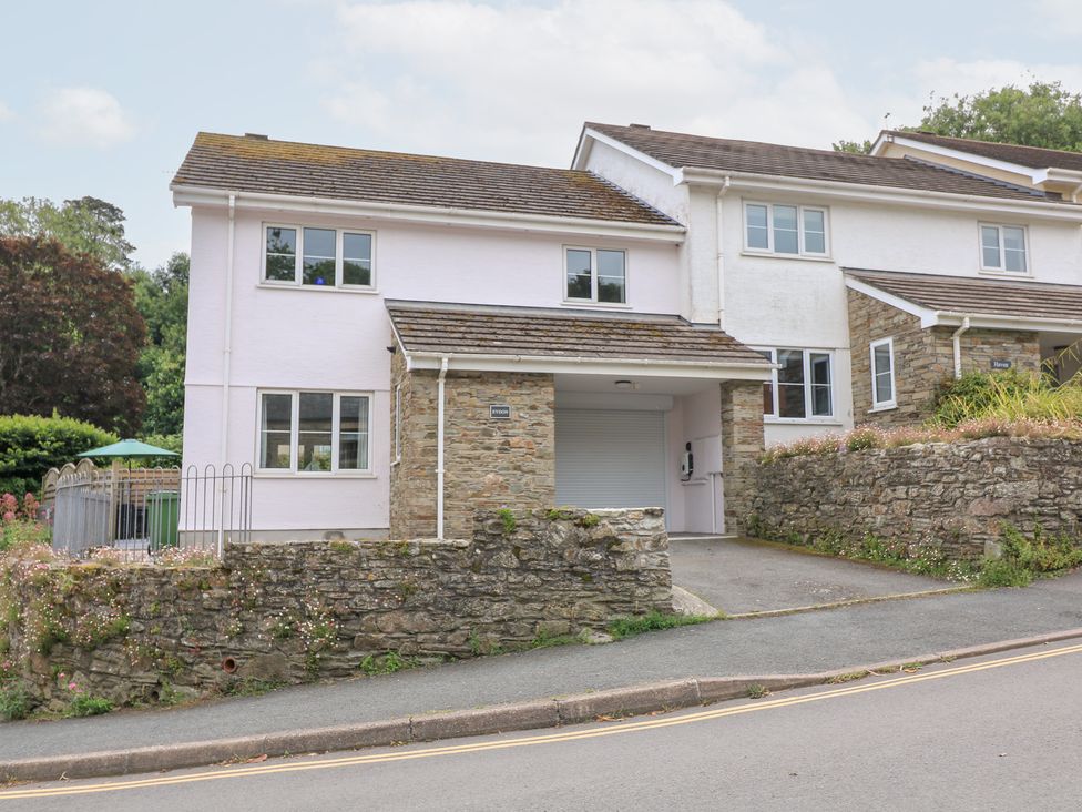 A house with a garage and stone wall at Eydon in Salcombe