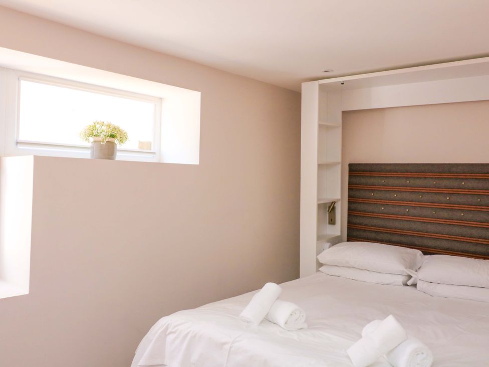 A bedroom with a bed and a window at Eydon in Salcombe