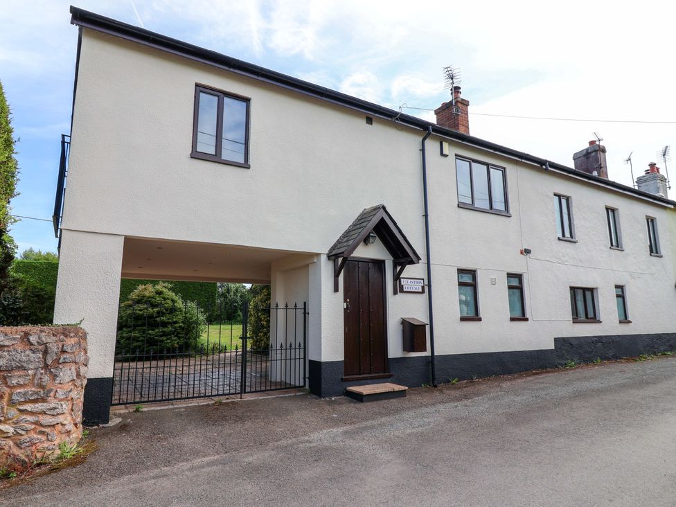 An exterior view of a building with windows and a gate at 1 Eastdon Cottages in Exeter