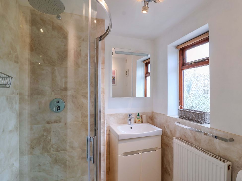 A bathroom with a shower and sink at 1 Eastdon Cottages in Exeter