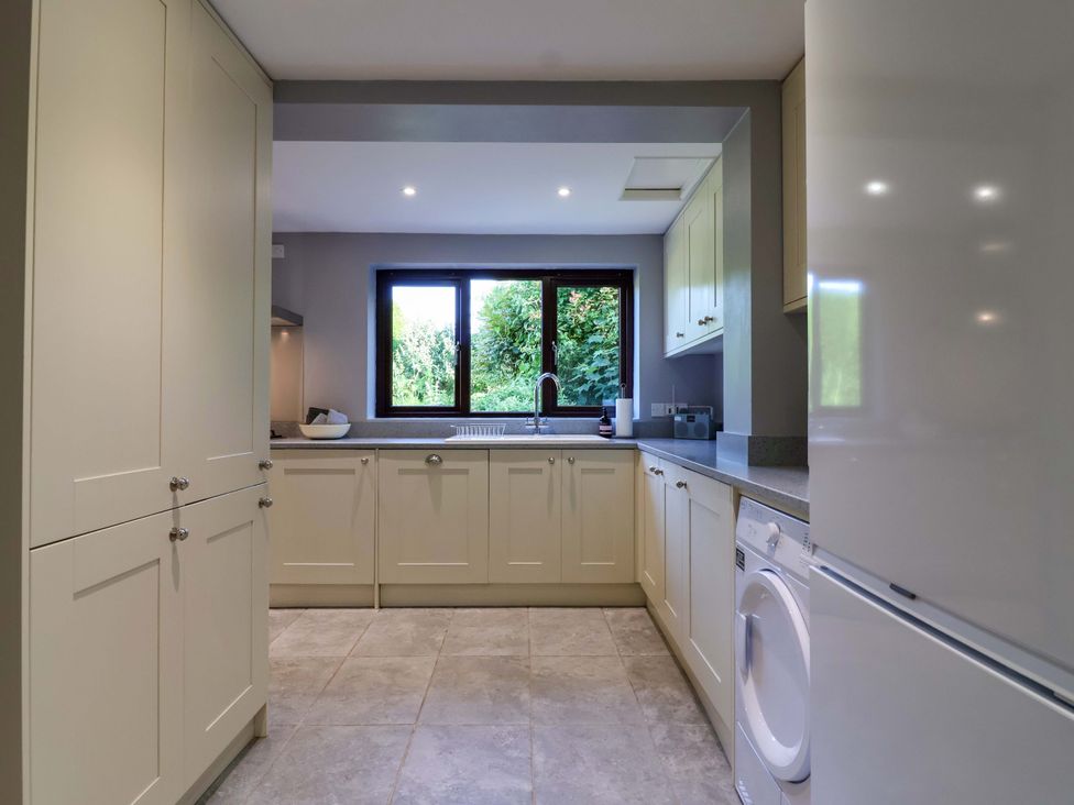 A kitchen with cabinets and a sink at 1 Eastdon Cottages Exeter