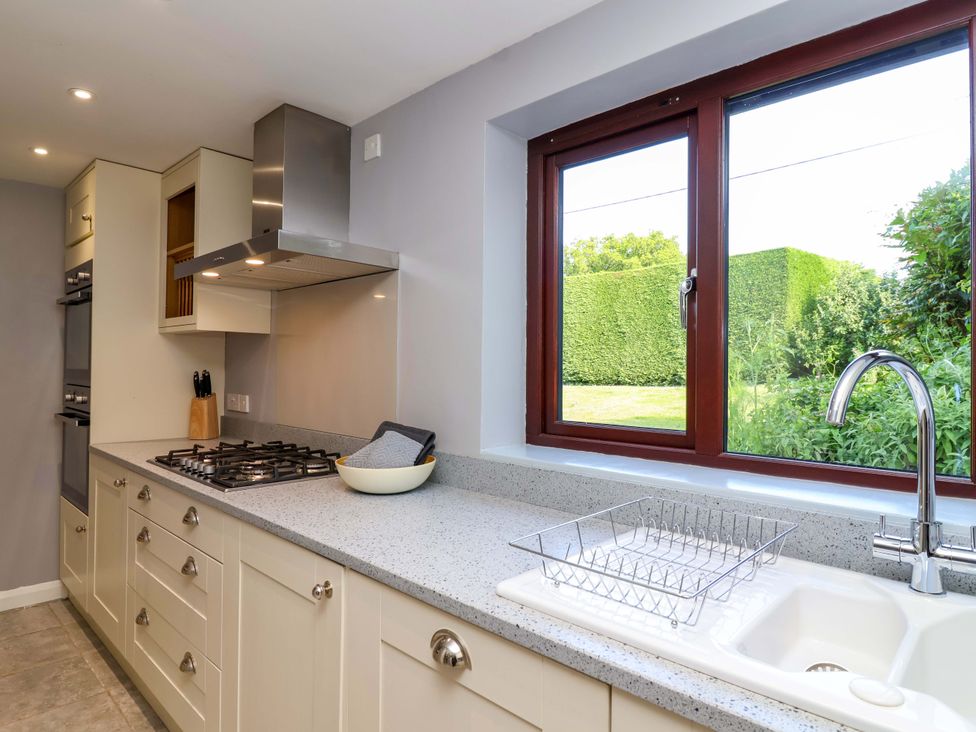 A kitchen with a sink and window at 1 Eastdon Cottages in Exeter