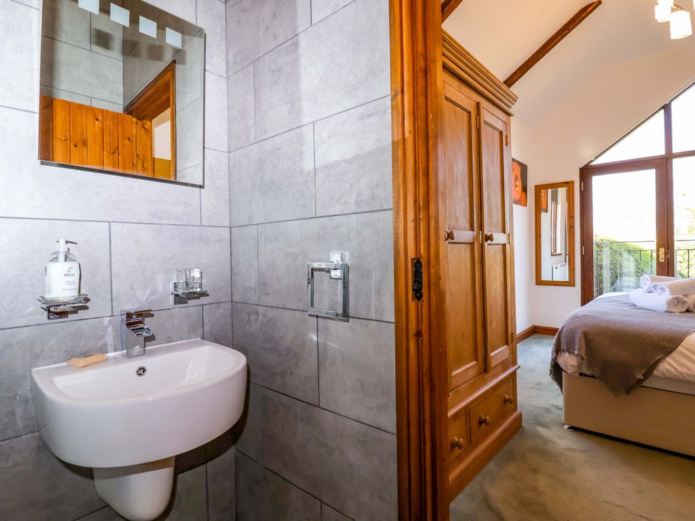 A bathroom with a sink and mirror at 1 Eastdon Cottages in Exeter