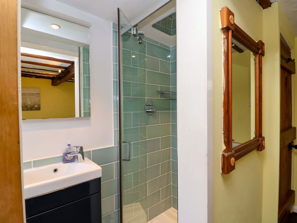 A bathroom with a shower and sink at 1 Eastdon Cottages in Exeter
