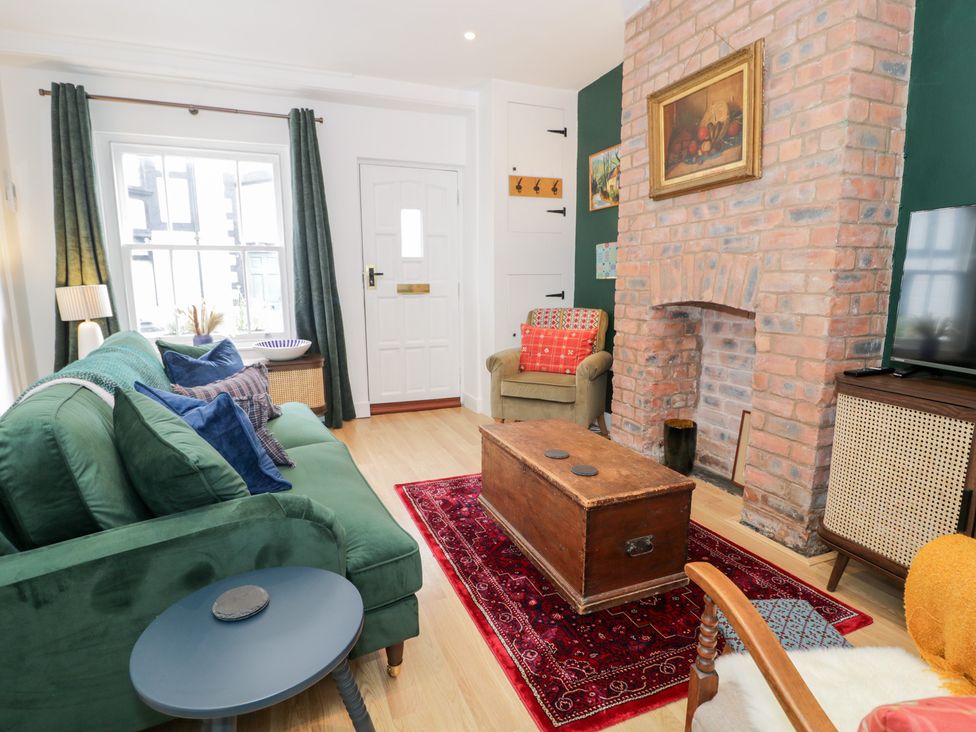 A living room with a sofa and coffee table at Derwen House in Llangollen