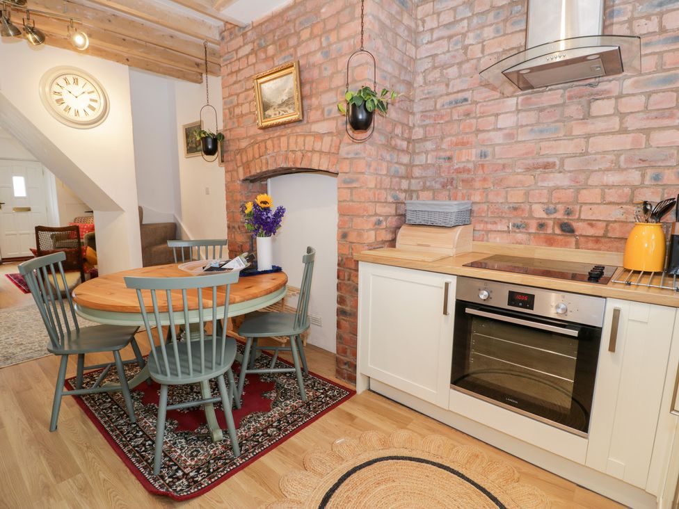 A kitchen with a round table and chairs at Derwen House Llangollen