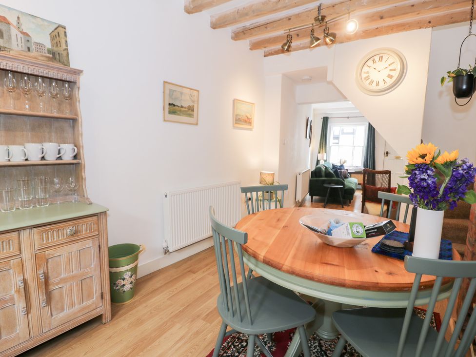 A dining room with a table and chairs at Derwen House in Llangollen