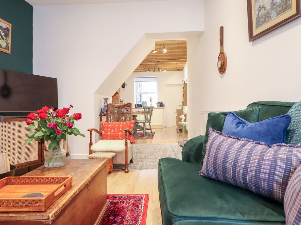 A living room with a sofa and coffee table at Derwen House in Llangollen