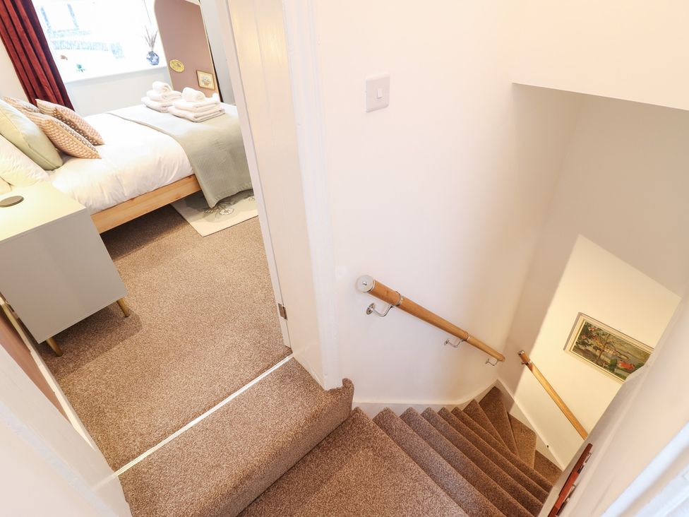 A staircase leading to a bedroom at Derwen House in Llangollen