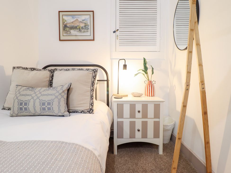 A bedroom with a bed and nightstand at Derwen House Llangollen