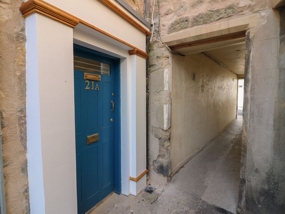 A doorway with number 21A and a pathway at 21A High Street Jedburgh