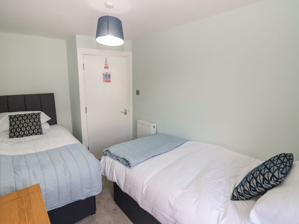 A bedroom with a double bed and a single bed at 21A High Street, Jedburgh