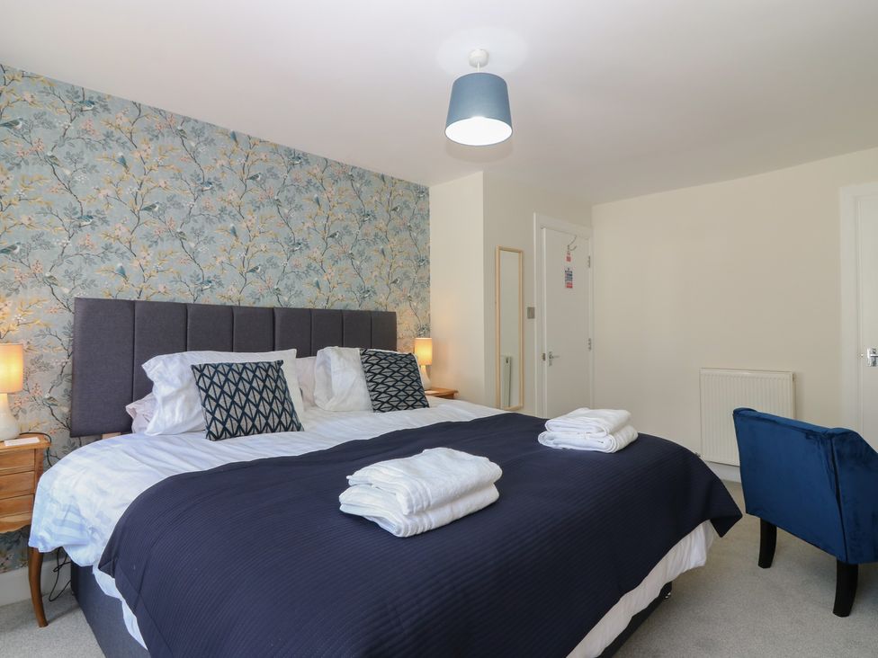 A bedroom with a bed and nightstands at 21A High Street in Jedburgh