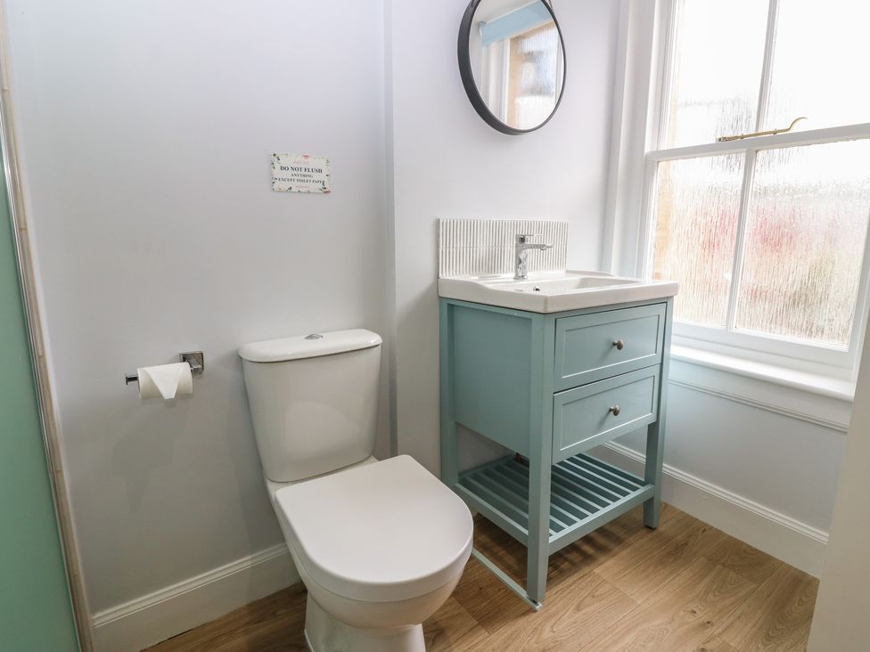 A bathroom with a toilet and sink at 21A High Street Jedburgh