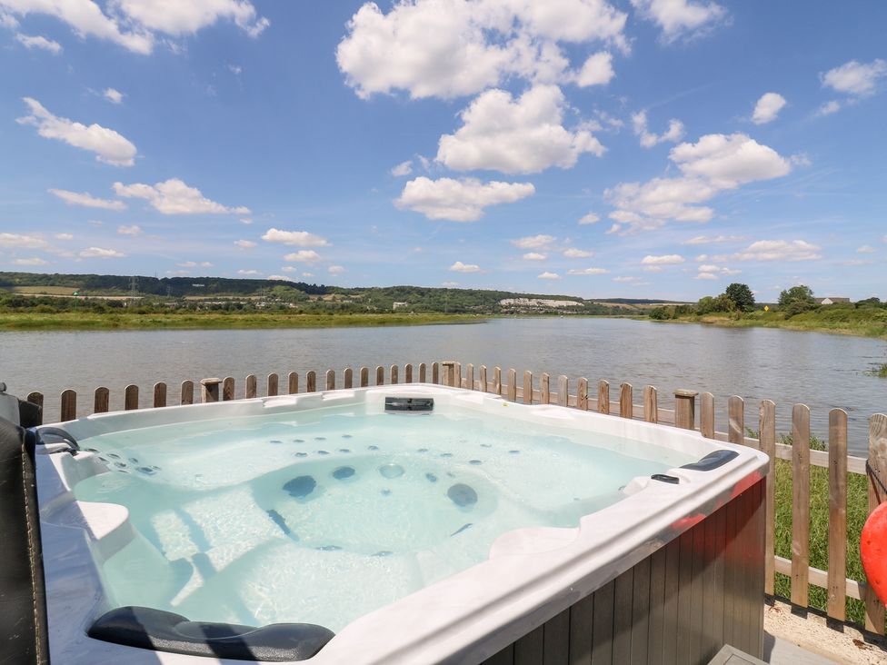 A hot tub overlooking a river at Haymens Wharf Wouldham