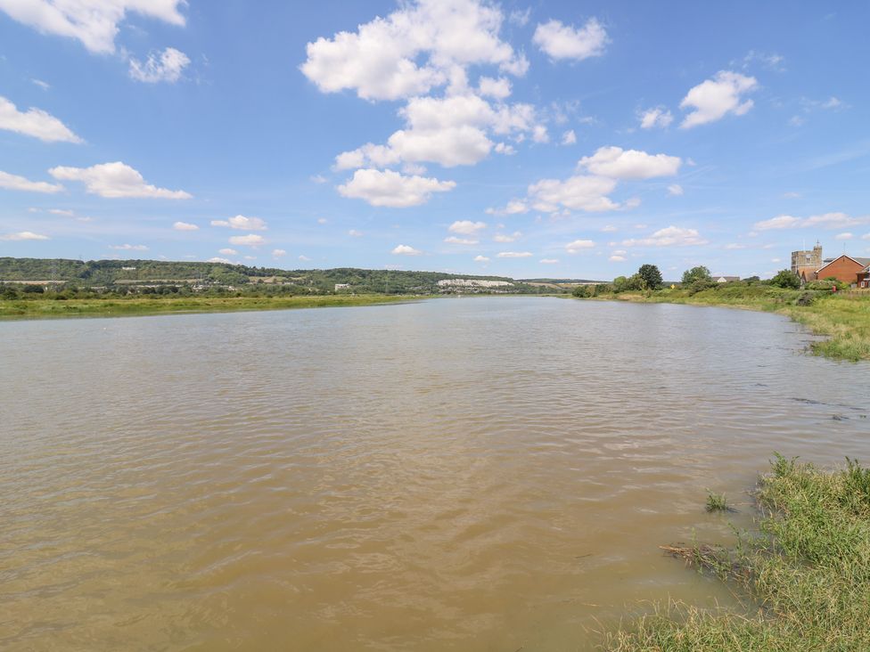 A river with grass and trees along the bank at Haymens Wharf in Wouldham