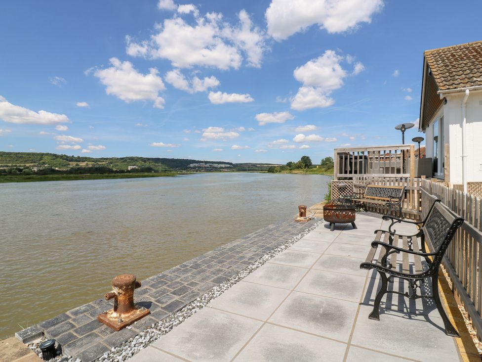 An outdoor area with benches and a river view at Haymens Wharf in Wouldham