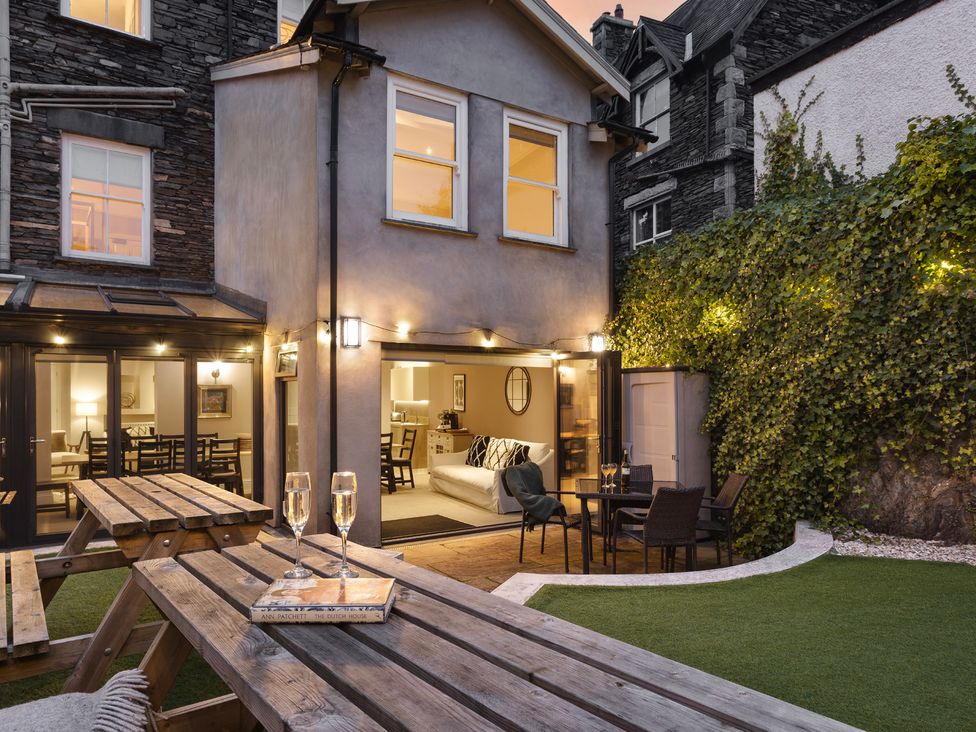 A garden with outdoor seating and a view of the house at Rosemount Boutique in Windermere