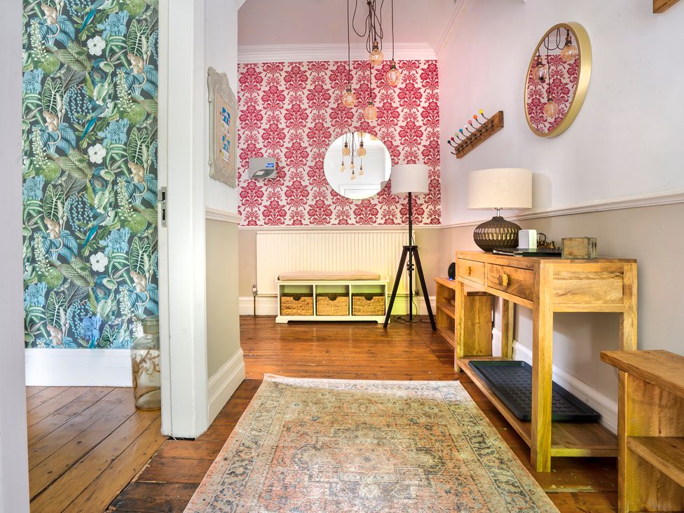 A hallway with a console table and mirror at Rosemount Boutique in Windermere