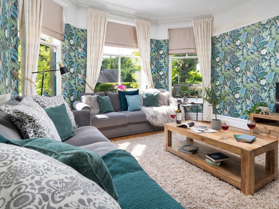 A living room with a sofa and coffee table at Rosemount Boutique in Windermere