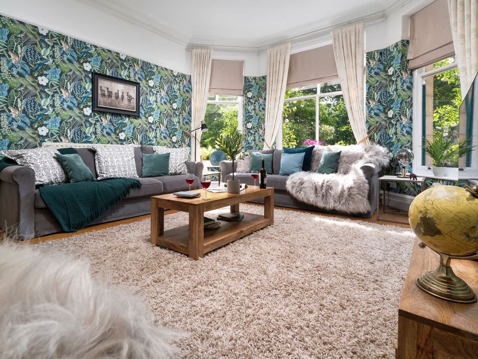 A living room with a sofa and coffee table at Rosemount Boutique in Windermere