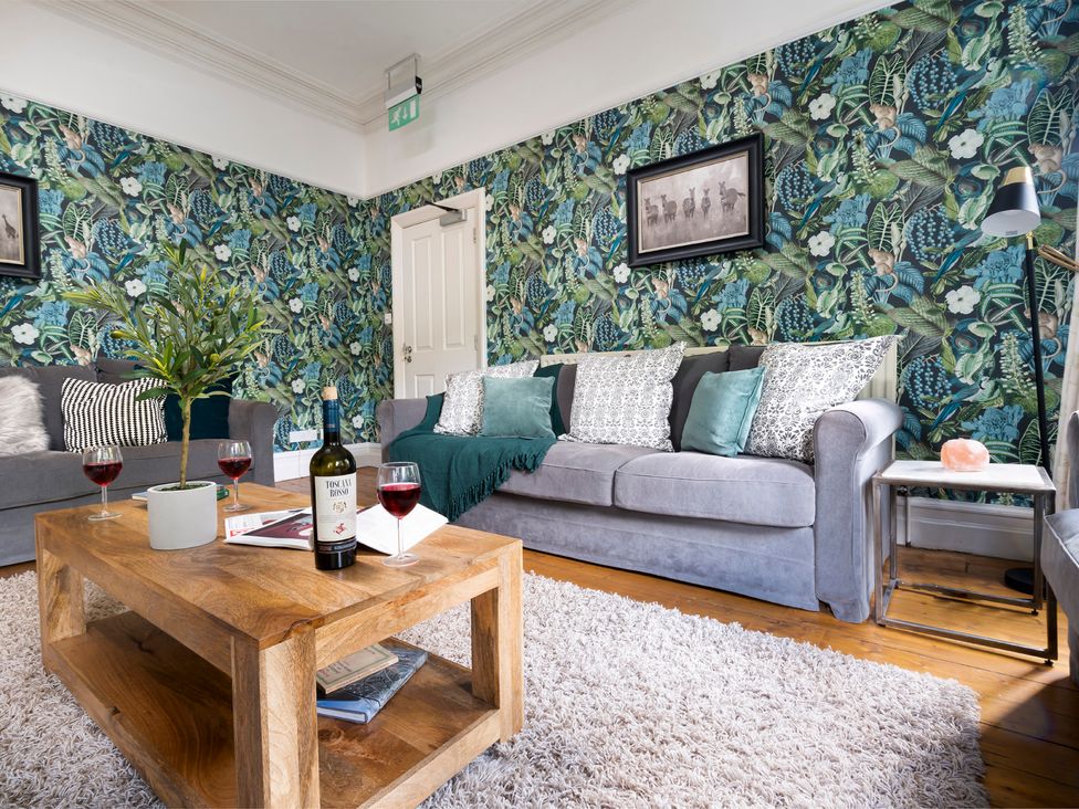 A living room with a sofa and coffee table at Rosemount Boutique in Windermere