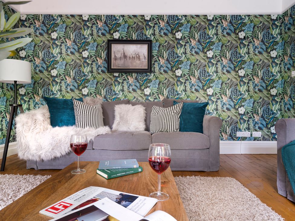 A living room with a sofa and coffee table at Rosemount Boutique in Windermere