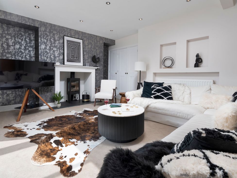 A living room with a sofa and a coffee table at Rosemount Boutique Windermere