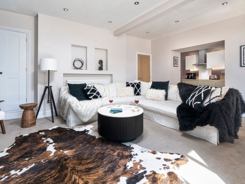 A living room with a sofa and coffee table at Rosemount Boutique in Windermere
