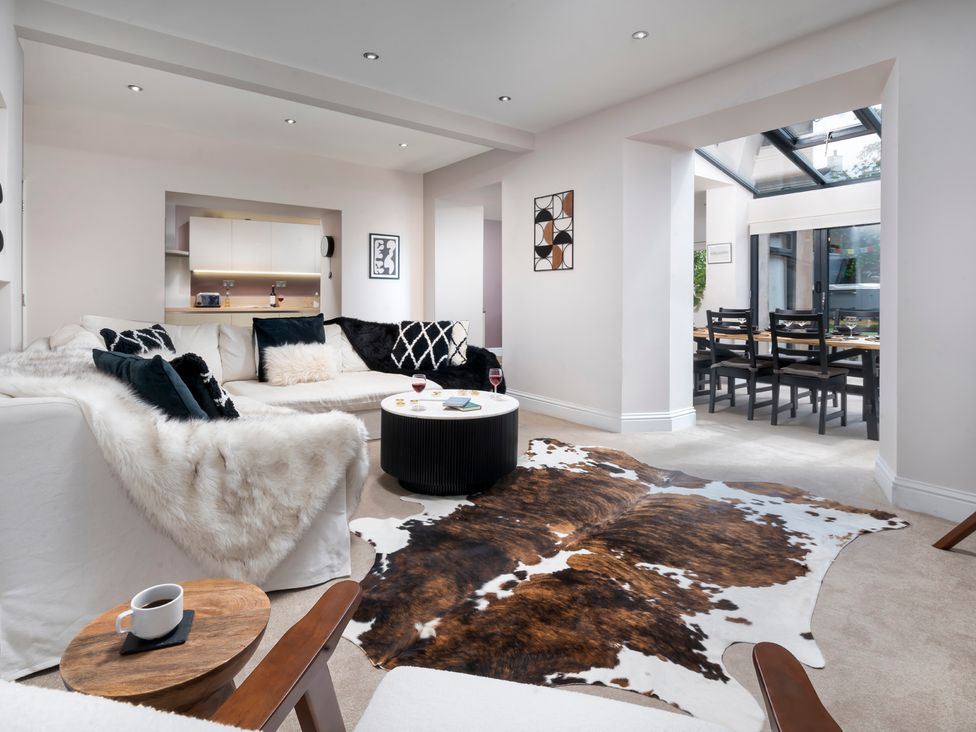 A living room with a sofa and coffee table at Rosemount Boutique in Windermere