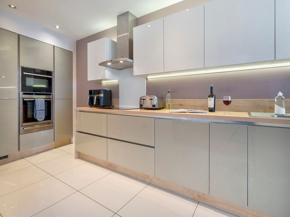 A kitchen with appliances and utensils at Rosemount Boutique in Windermere