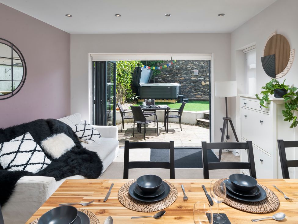 A dining area with a view to the outdoor patio at Rosemount Boutique Windermere