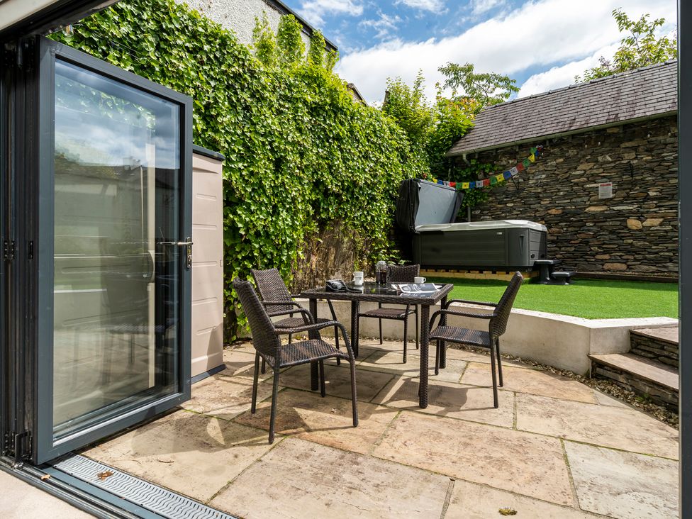 An outdoor patio with a table and chairs at Rosemount Boutique in Windermere