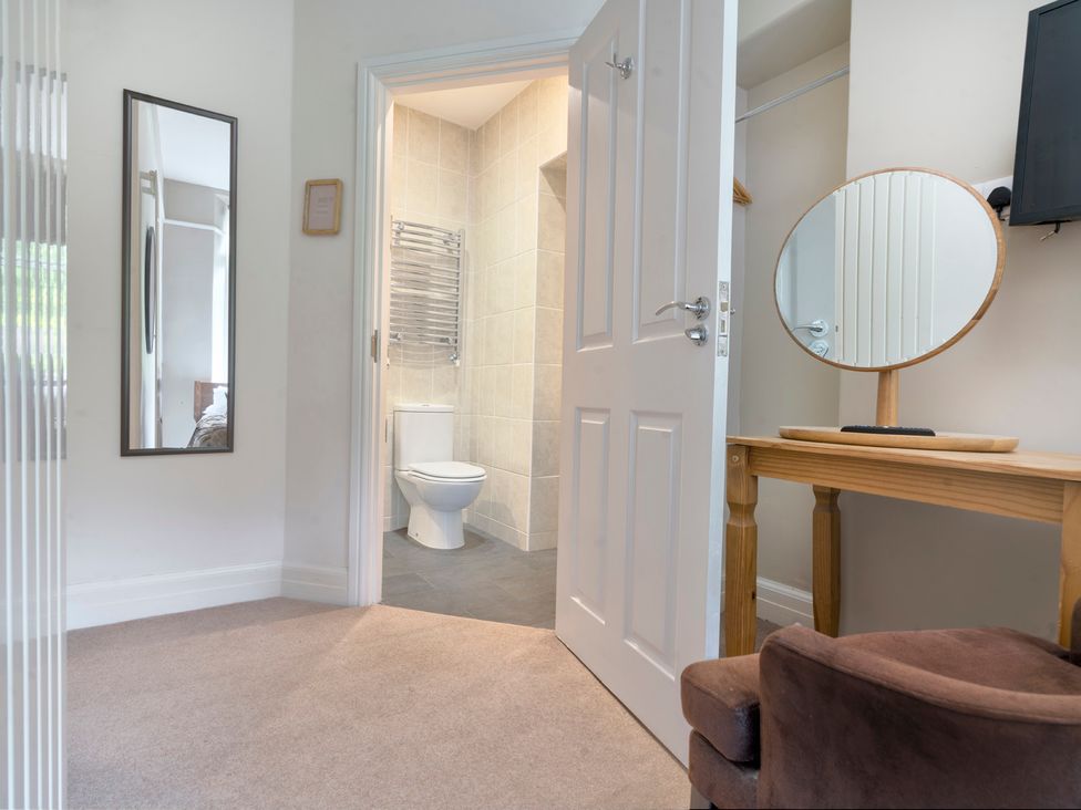 A bathroom with a toilet and hand towel rail at Rosemount Boutique in Windermere