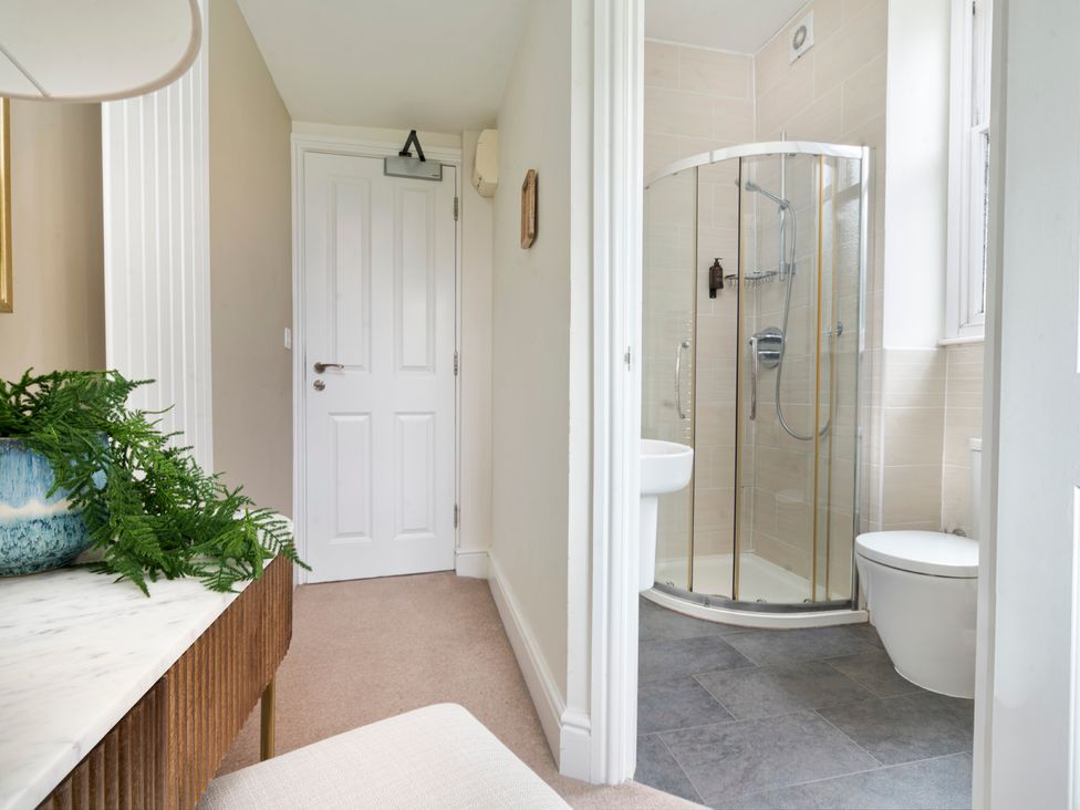 A bathroom with a shower, toilet, and sink at Rosemount Boutique in Windermere