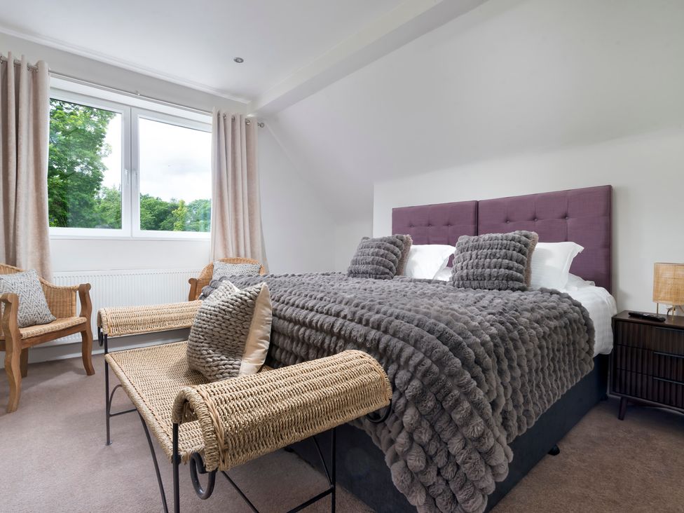 A bedroom featuring a bed with pillows and a window at Rosemount Boutique in Windermere