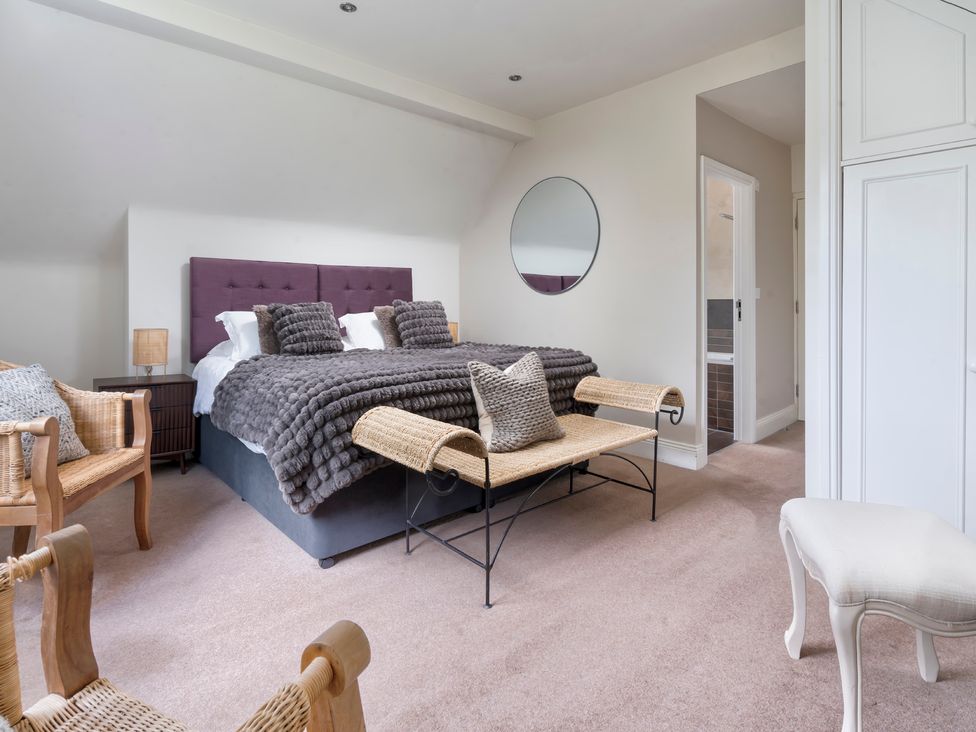 A bedroom with a bed and seating area at Rosemount Boutique in Windermere