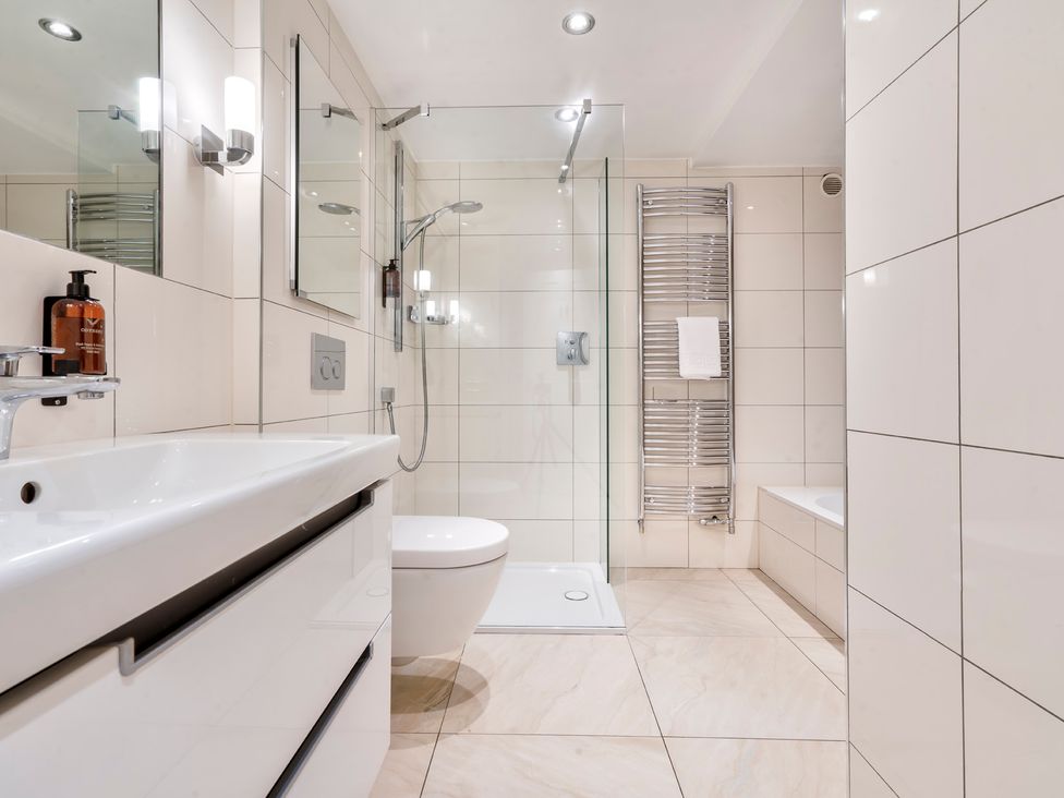 A bathroom with a sink, toilet, and shower at Rosemount Boutique in Windermere