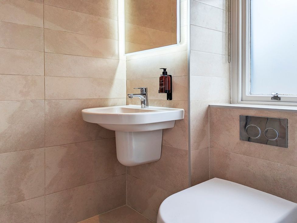 A bathroom with a sink and toilet at Rosemount Boutique in Windermere